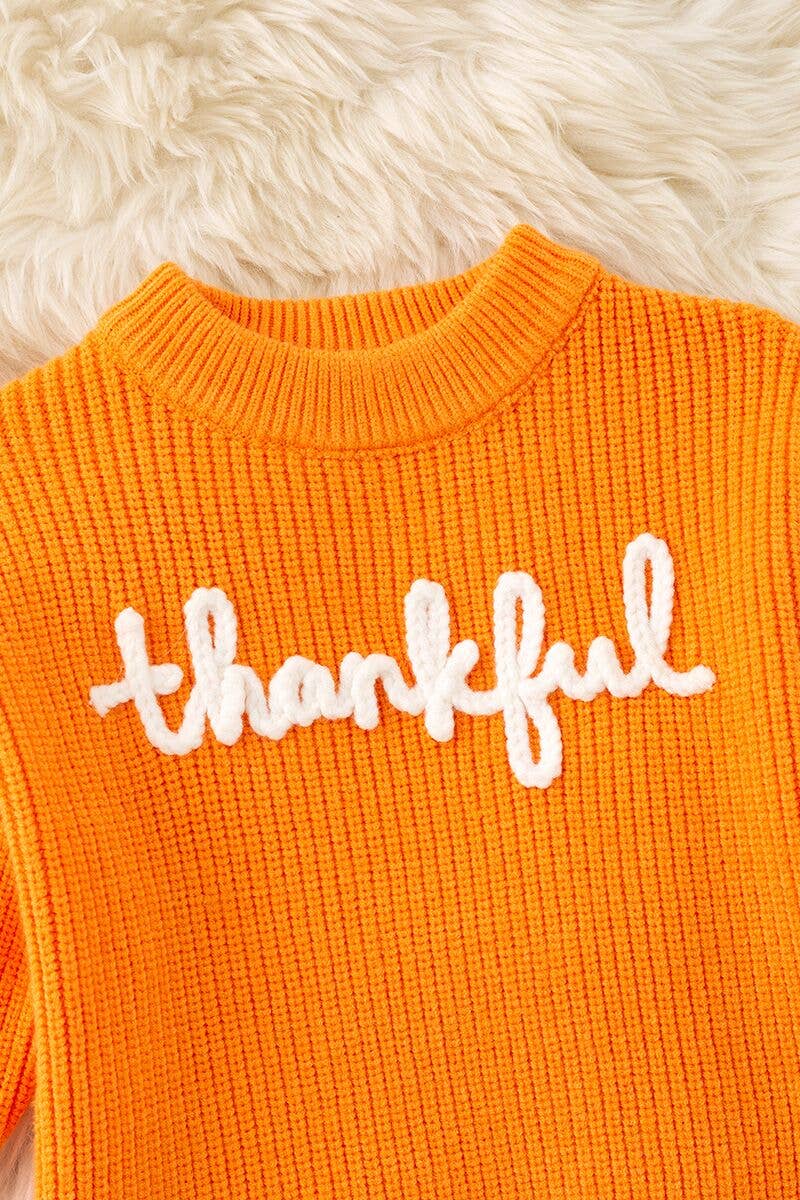 Orange Thankful knit sweater with embroidered flowers on sleeves. TPG60420 JEAN