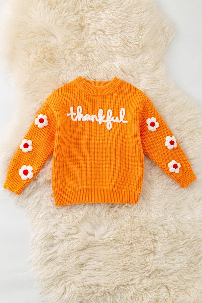 Orange Thankful knit sweater with embroidered flowers on sleeves. TPG60420 JEAN